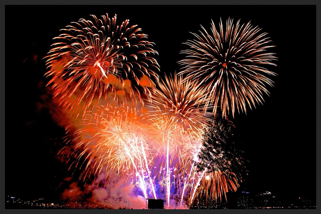 Massive orange fireworks bursting over the Han River during the Seoul World Fireworks Festival